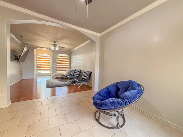 a living room with furniture a rug and a large window