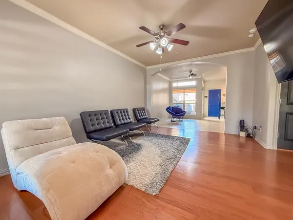 a living room with furniture and a chandelier