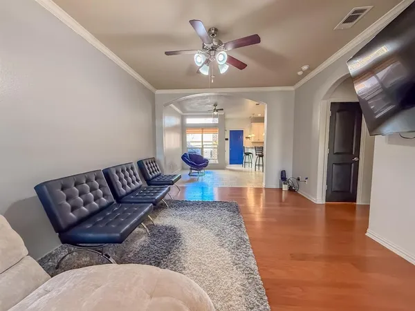 a living room with furniture and a chandelier
