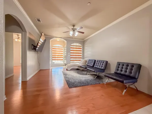 a spacious bedroom with furniture and a rug