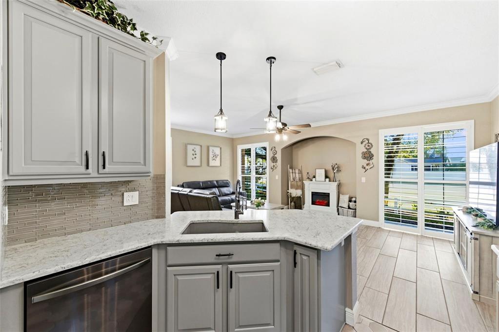 8408 Shallow Creek Court New Port Richey, FL 34653 - Photo 15 of 47 a kitchen with stainless steel appliances granite countertop a stove a sink and a window