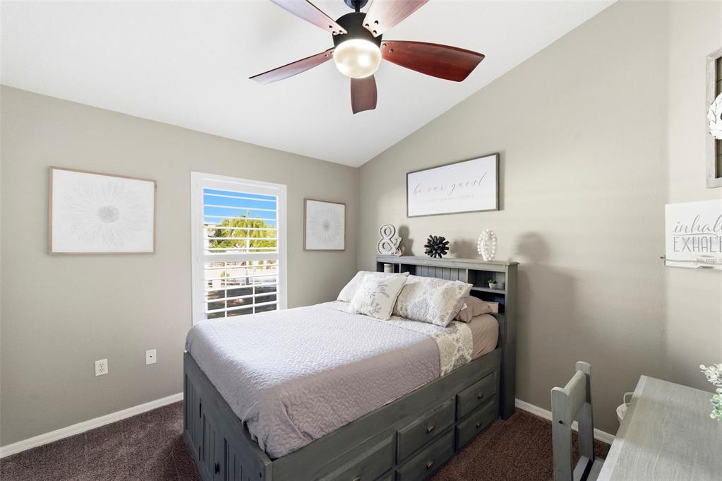 8408 Shallow Creek Court New Port Richey, FL 34653 - Photo 26 of 47 a bedroom with a bed and a window