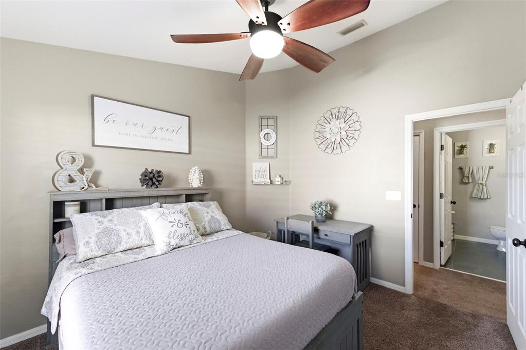 8408 Shallow Creek Court New Port Richey, FL 34653 - Photo 27 of 47 a bedroom with a bed and a chandelier