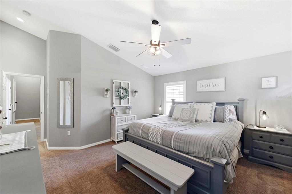 8408 Shallow Creek Court New Port Richey, FL 34653 - Photo 31 of 47 a bedroom with a bed and a chandelier