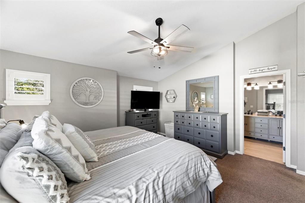 8408 Shallow Creek Court New Port Richey, FL 34653 - Photo 32 of 47 a bedroom with a large bed and a tv