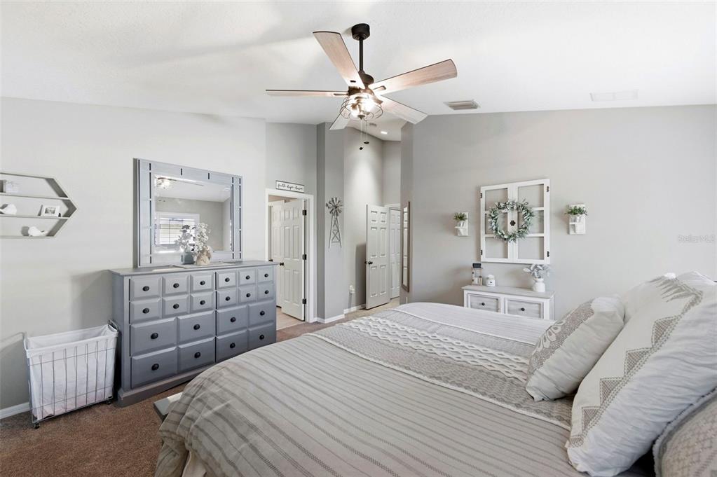 8408 Shallow Creek Court New Port Richey, FL 34653 - Photo 33 of 47 a bedroom with a bed and a chandelier