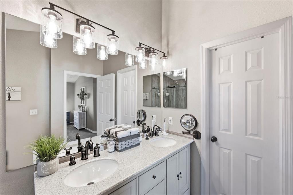 8408 Shallow Creek Court New Port Richey, FL 34653 - Photo 35 of 47 a bathroom with a sink a mirror and a shower curtain