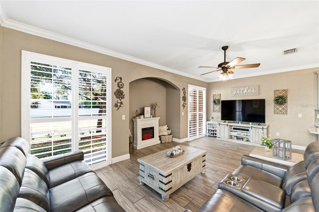 8408 Shallow Creek Court New Port Richey, FL 34653 - Photo 6 of 47 a living room with furniture a flat screen tv and a window