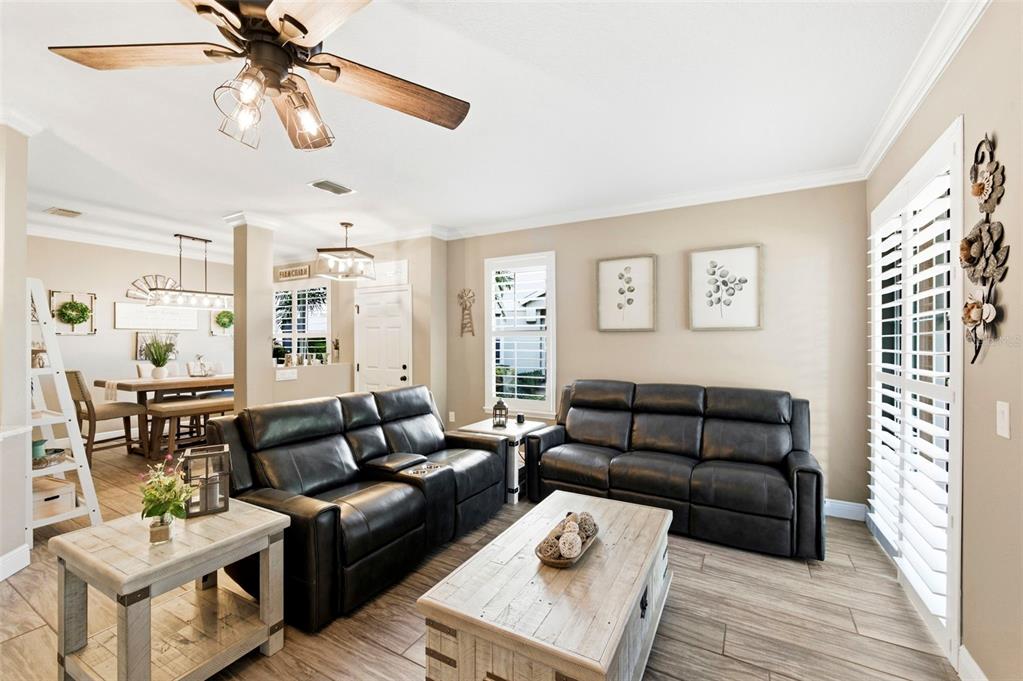 8408 Shallow Creek Court New Port Richey, FL 34653 - Photo 8 of 47 a living room with furniture or couch and a chandelier
