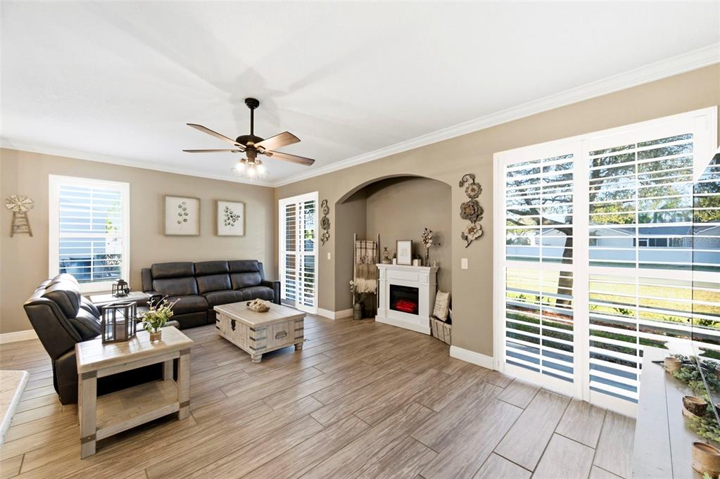 8408 Shallow Creek Court New Port Richey, FL 34653 - Photo 10 of 47 a living room with furniture and a fireplace