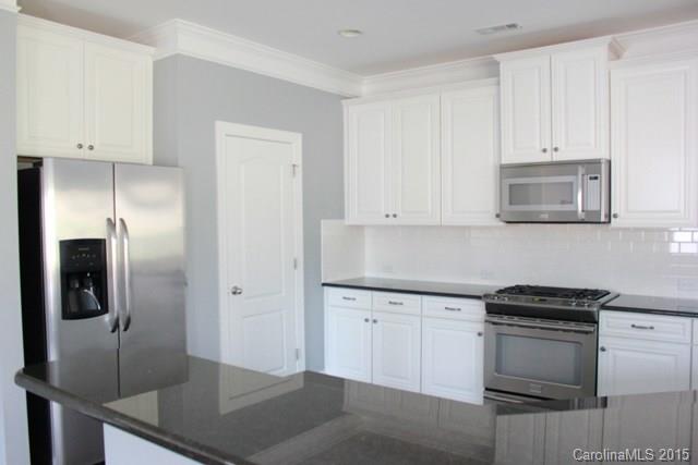 1028 Ridgehaven Road Waxhaw, NC 28173 - Photo 8 of 18 a kitchen with stainless steel appliances granite countertop a sink a stove and refrigerator