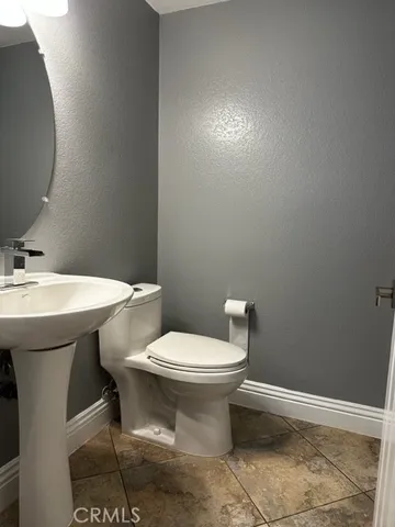 a bathroom with a sink toilet and a mirror