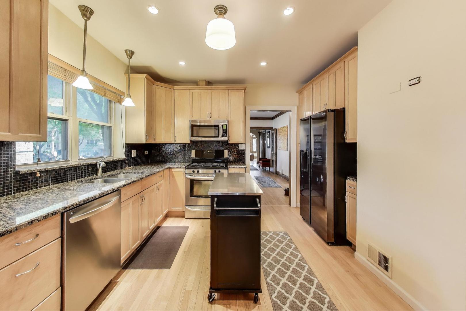 2700 West Carmen Avenue Chicago, IL 60625 - Photo 13 of 34 a kitchen with stainless steel appliances granite countertop a refrigerator a sink and a stove
