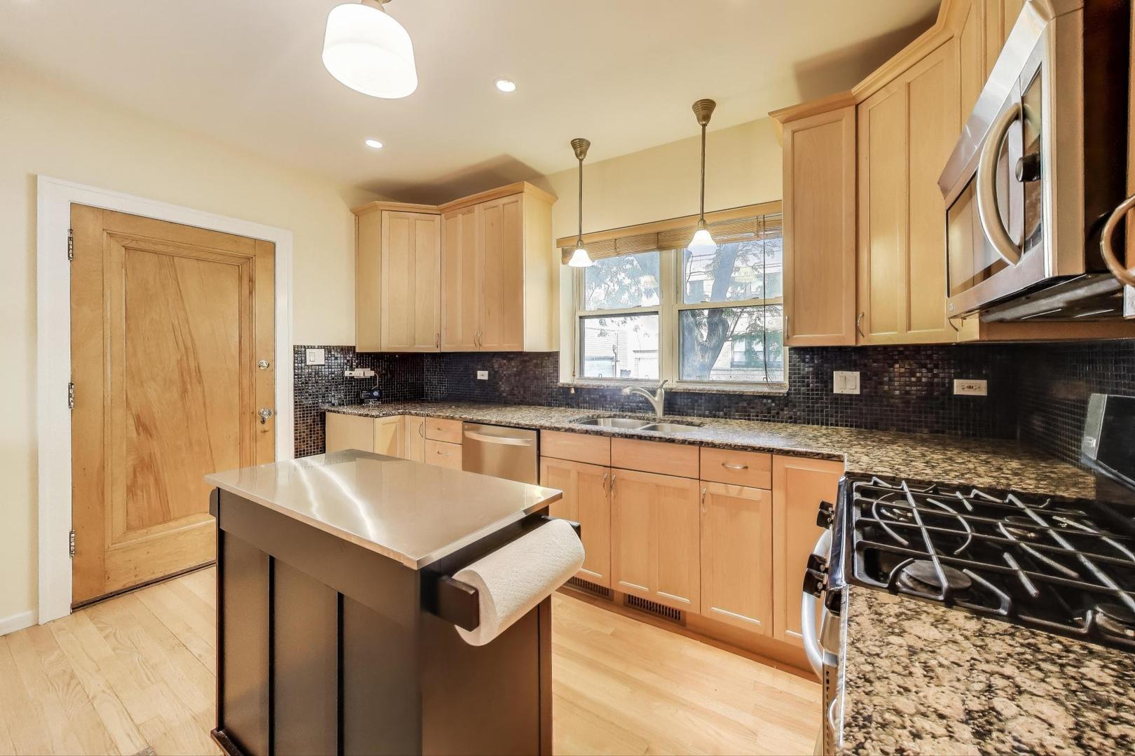 2700 West Carmen Avenue Chicago, IL 60625 - Photo 14 of 34 a kitchen with a sink stove and cabinets