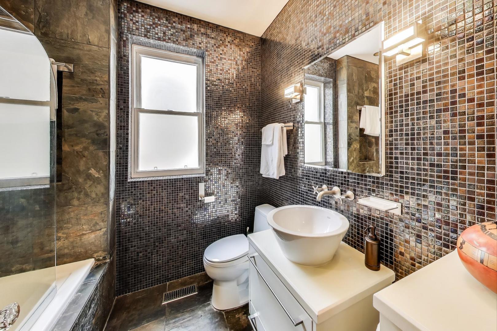 2700 West Carmen Avenue Chicago, IL 60625 - Photo 20 of 34 a bathroom with a toilet sink mirror and shower