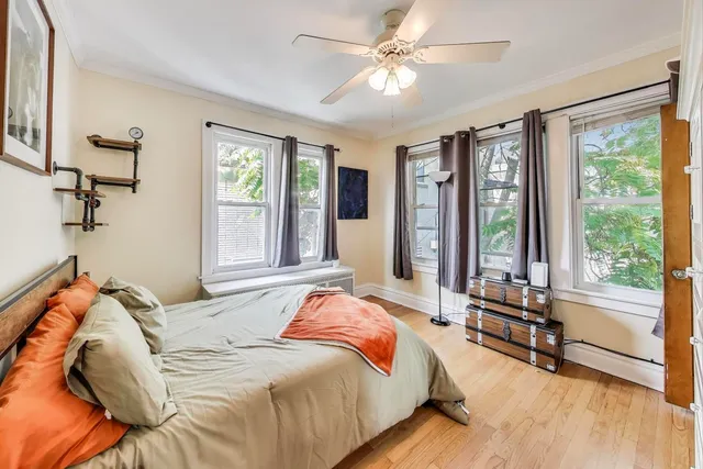 a bedroom with a bed dresser and a large mirror