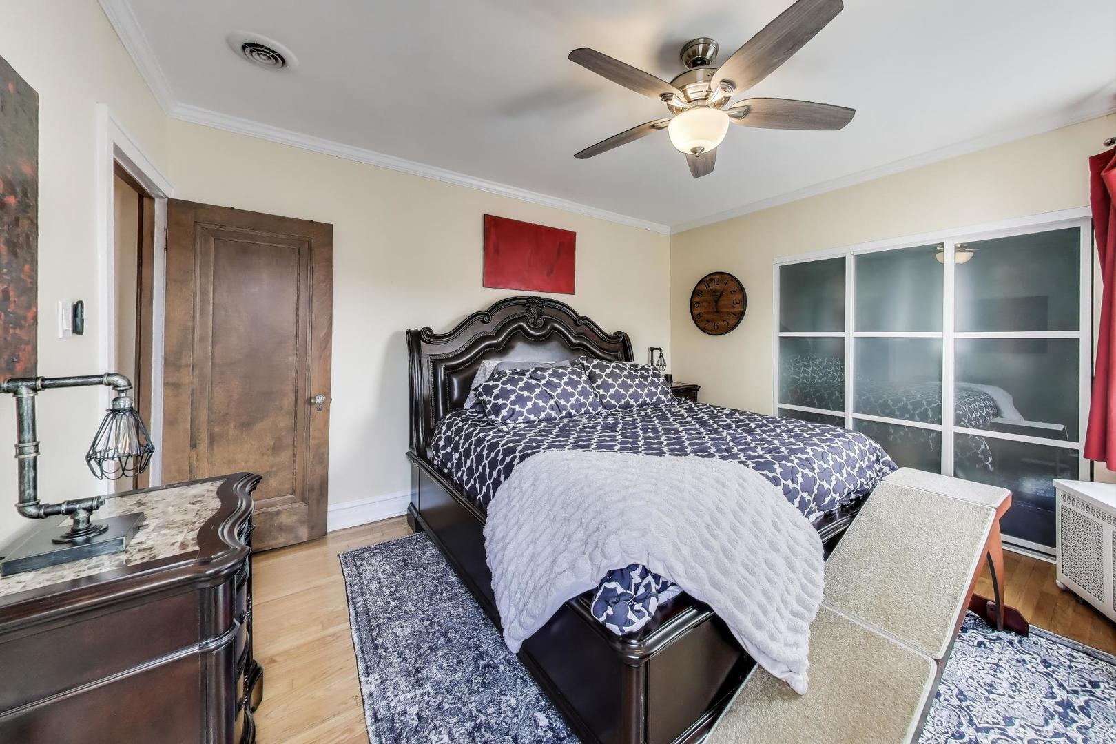 2700 West Carmen Avenue Chicago, IL 60625 - Photo 29 of 34 a bedroom with a bed dresser and a large mirror