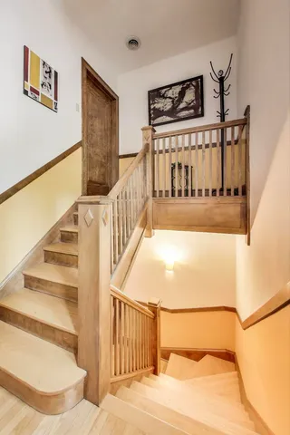 a hallway with a couch and wooden floor
