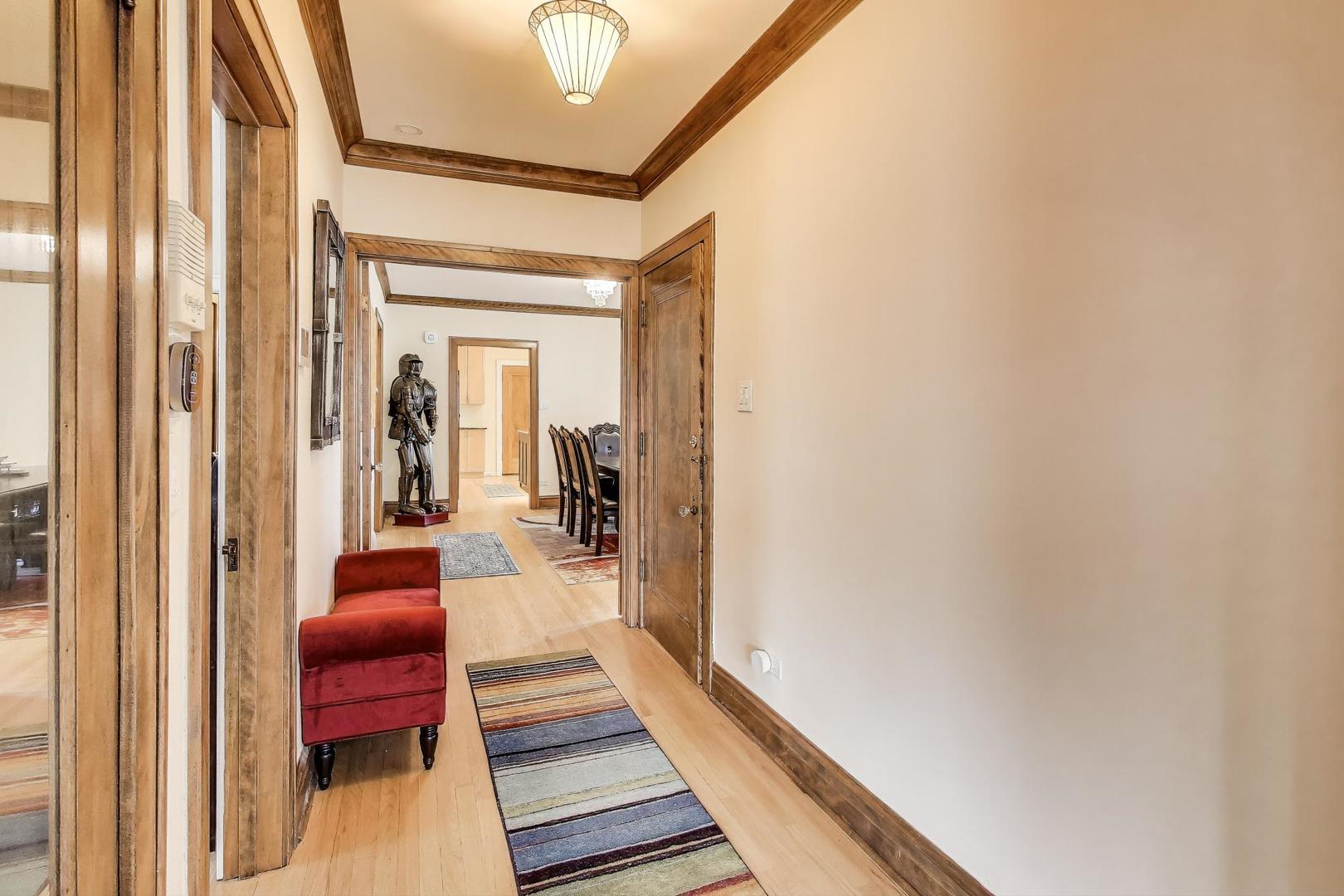2700 West Carmen Avenue Chicago, IL 60625 - Photo 5 of 34 a hallway with a couch and wooden floor