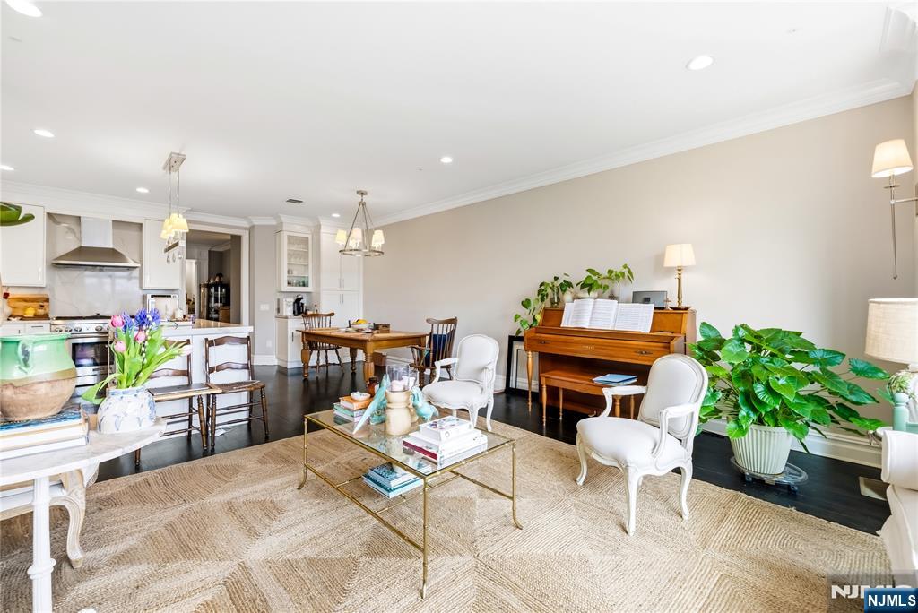 1228 River Road Edgewater, NJ 07020 - Photo 11 of 49 a living room with furniture and a dining table with potted plants