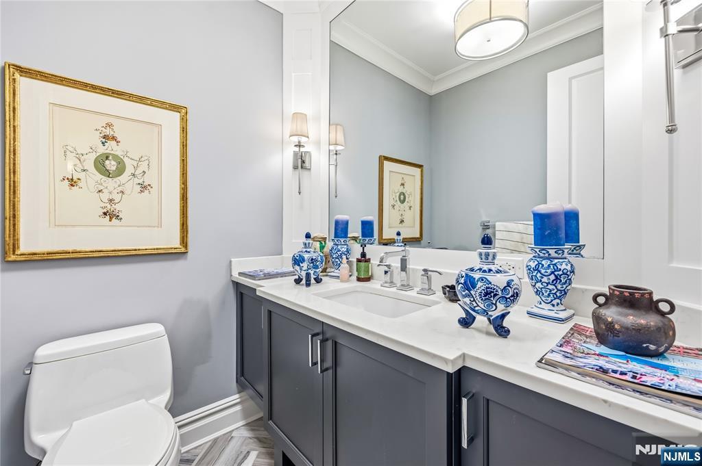 1228 River Road Edgewater, NJ 07020 - Photo 12 of 49 a bathroom with a toilet sink and mirror