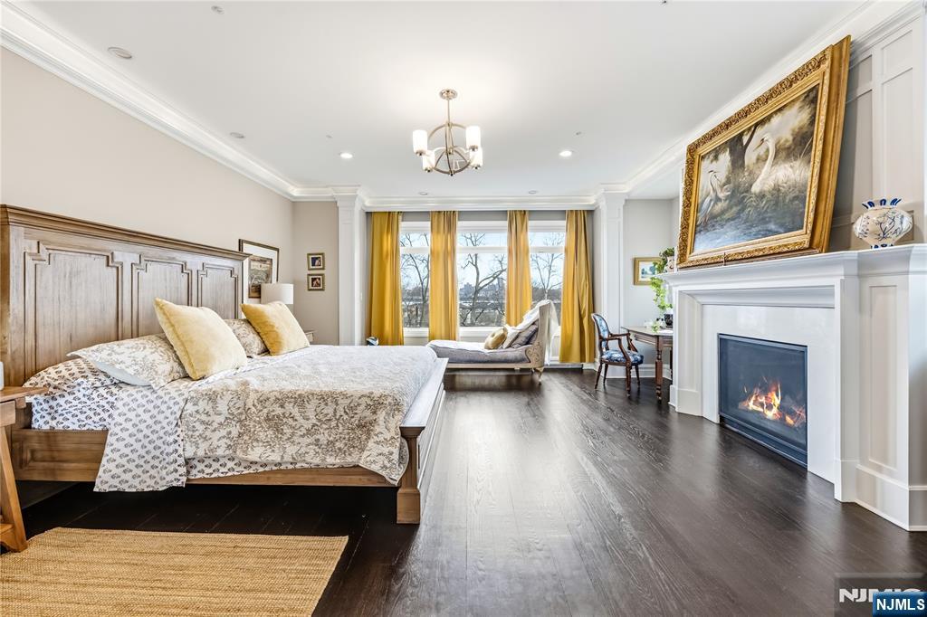 1228 River Road Edgewater, NJ 07020 - Photo 13 of 49 a bedroom with a bed and a fireplace