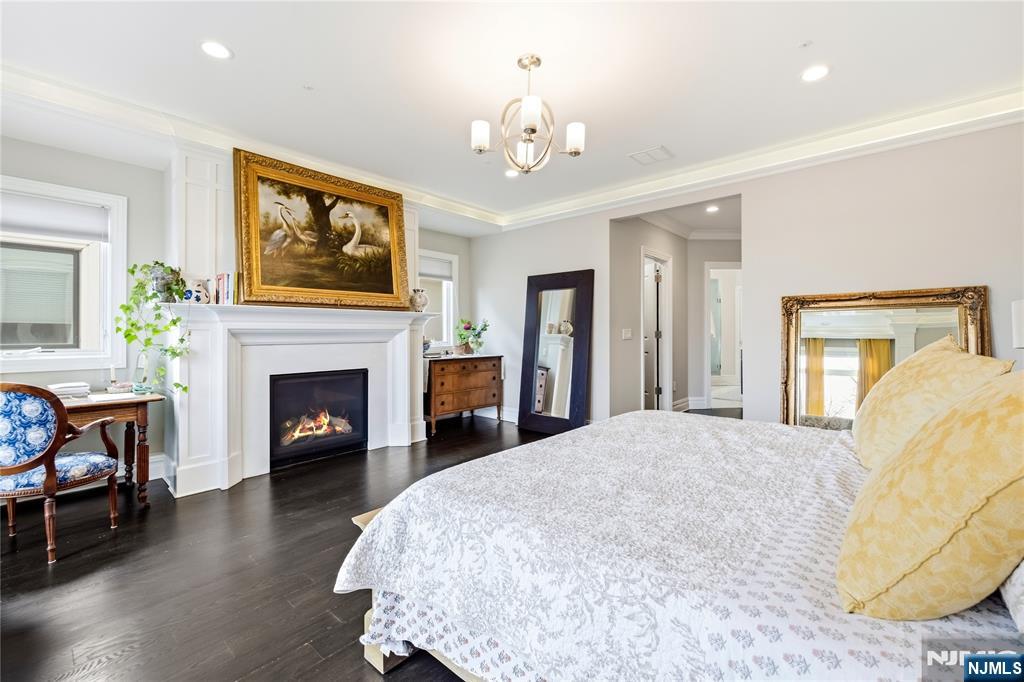 1228 River Road Edgewater, NJ 07020 - Photo 15 of 49 a spacious bedroom with a bed and a fireplace