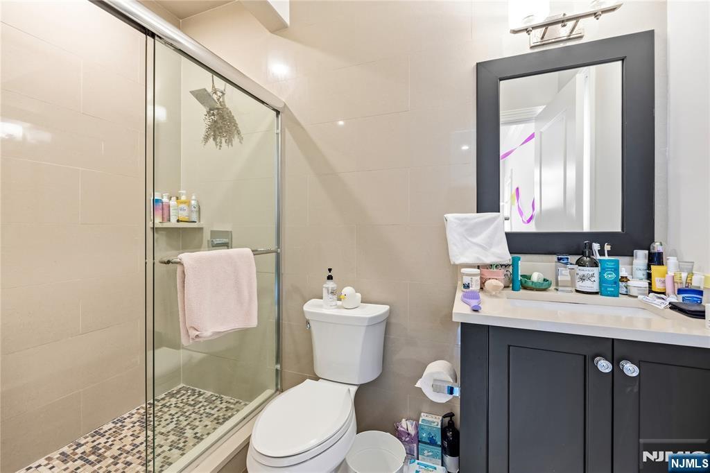 1228 River Road Edgewater, NJ 07020 - Photo 23 of 49 a bathroom with a sink a toilet and shower