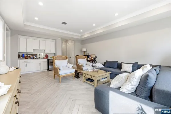 a living room with furniture or kitchen view and a wooden floor
