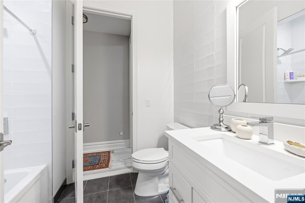 1228 River Road Edgewater, NJ 07020 - Photo 28 of 49 a bathroom with a sink toilet and shower