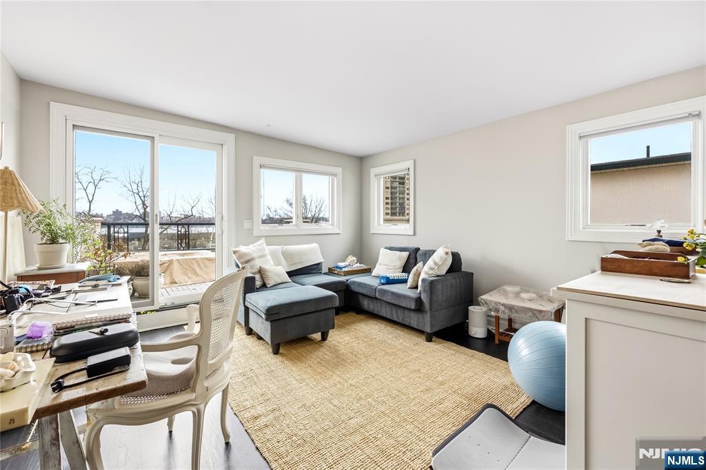 1228 River Road Edgewater, NJ 07020 - Photo 32 of 49 a living room with furniture and a large window