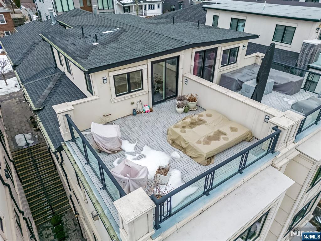 1228 River Road Edgewater, NJ 07020 - Photo 47 of 49 a view of a patio with table and chairs and wooden floor