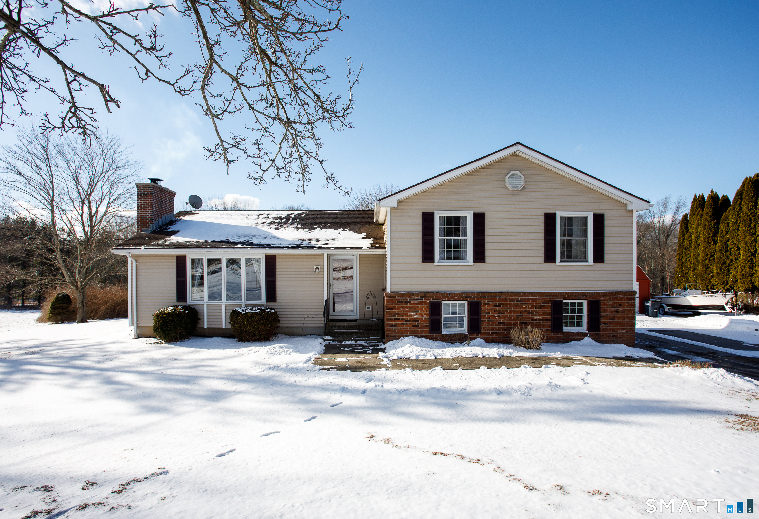 a view of a house with a snow in the yard