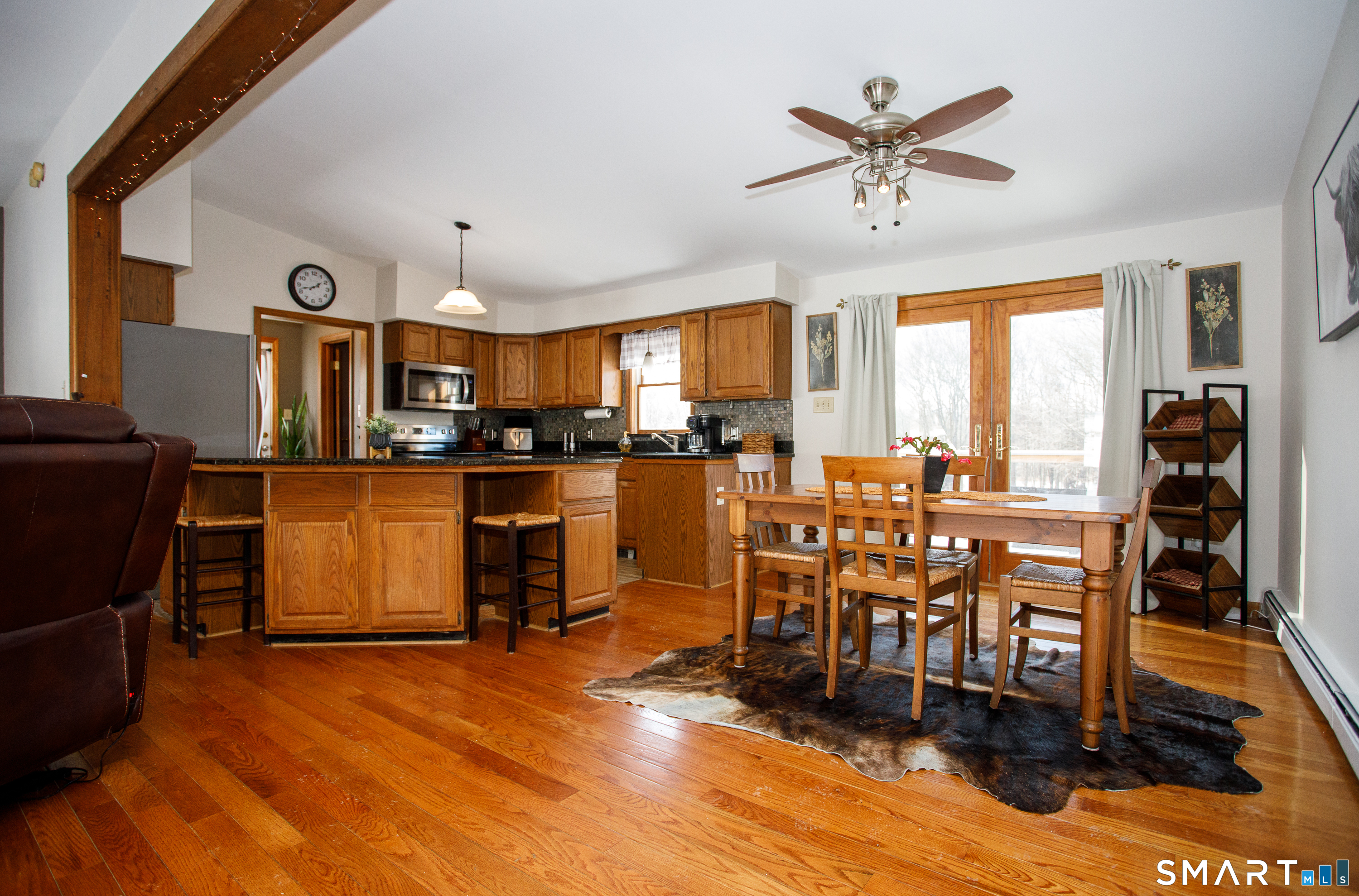 110 Pautipaug Hill Road Sprague, CT 06330 - Photo 2 of 33 a kitchen with stainless steel appliances kitchen island granite countertop a table chairs and a refrigerator