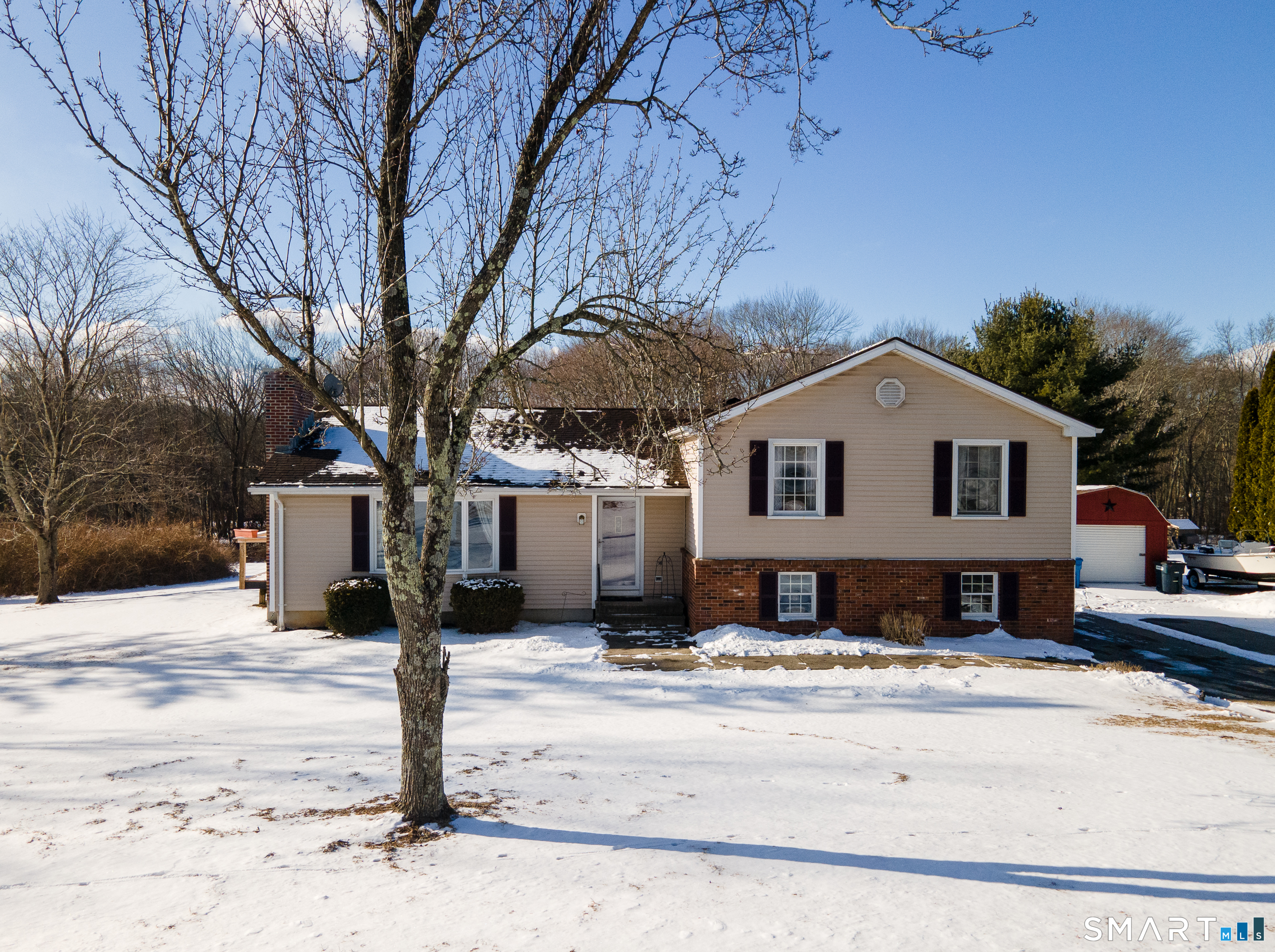 110 Pautipaug Hill Road Sprague, CT 06330 - Photo 33 of 33 a front view of a house with a yard covered in snow