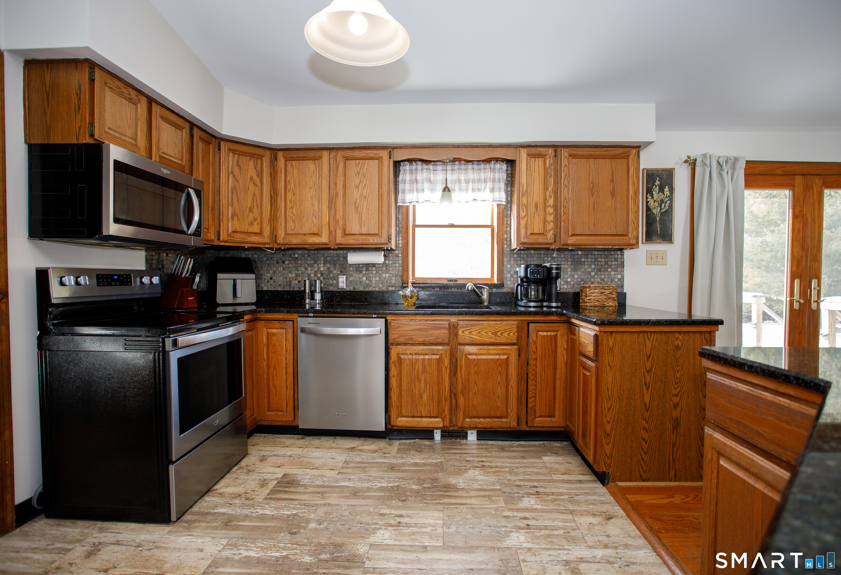 110 Pautipaug Hill Road Sprague, CT 06330 - Photo 6 of 33 a kitchen with stainless steel appliances granite countertop a stove a sink and a refrigerator