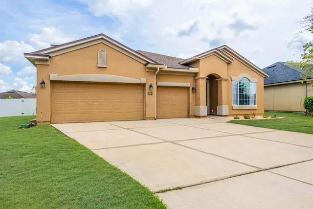 a view of an empty room with a cabinet and a window