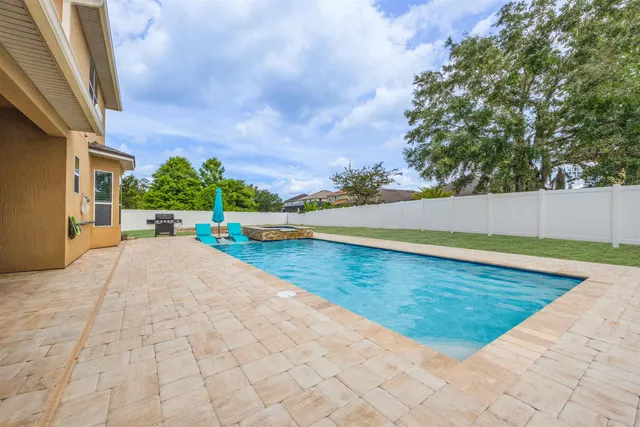 a view of swimming pool with lounge chair