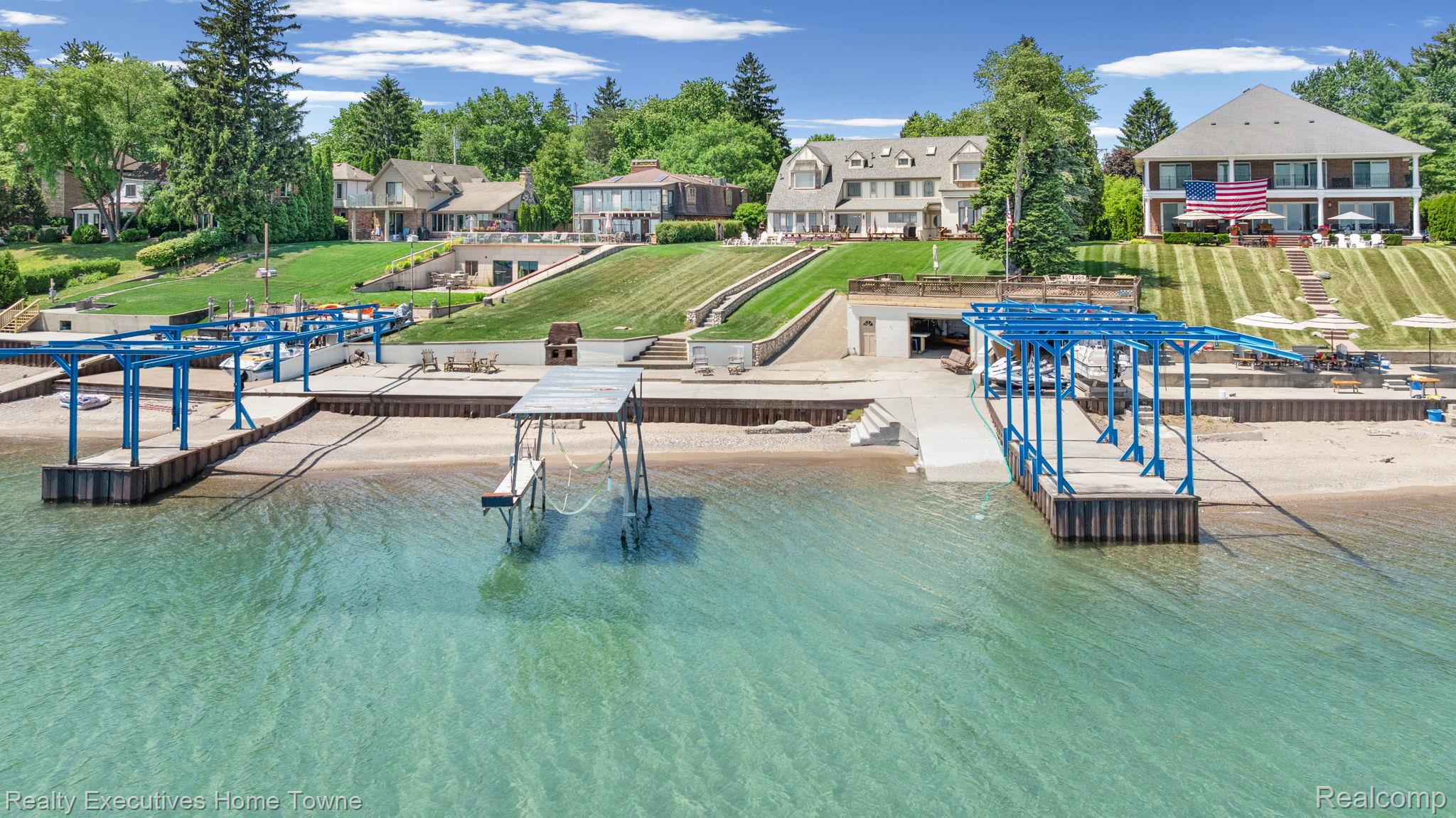 8308 Lakeshore Road Fort Gratiot, MI 48059 - Photo 16 of 79 Expansive waterfront property featuring a private boat dock with multiple slips, a concrete boat ramp, and a sandy beach