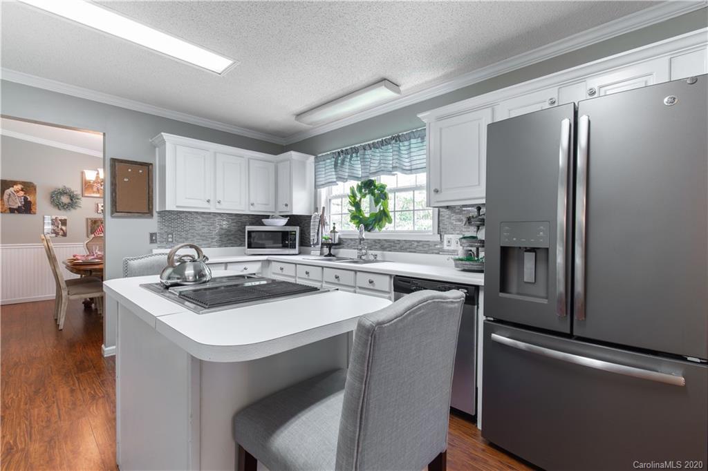 2229 Flat Creek Road Lancaster, SC 29720 - Photo 22 of 29 a kitchen with stainless steel appliances granite countertop a sink stove refrigerator and a window