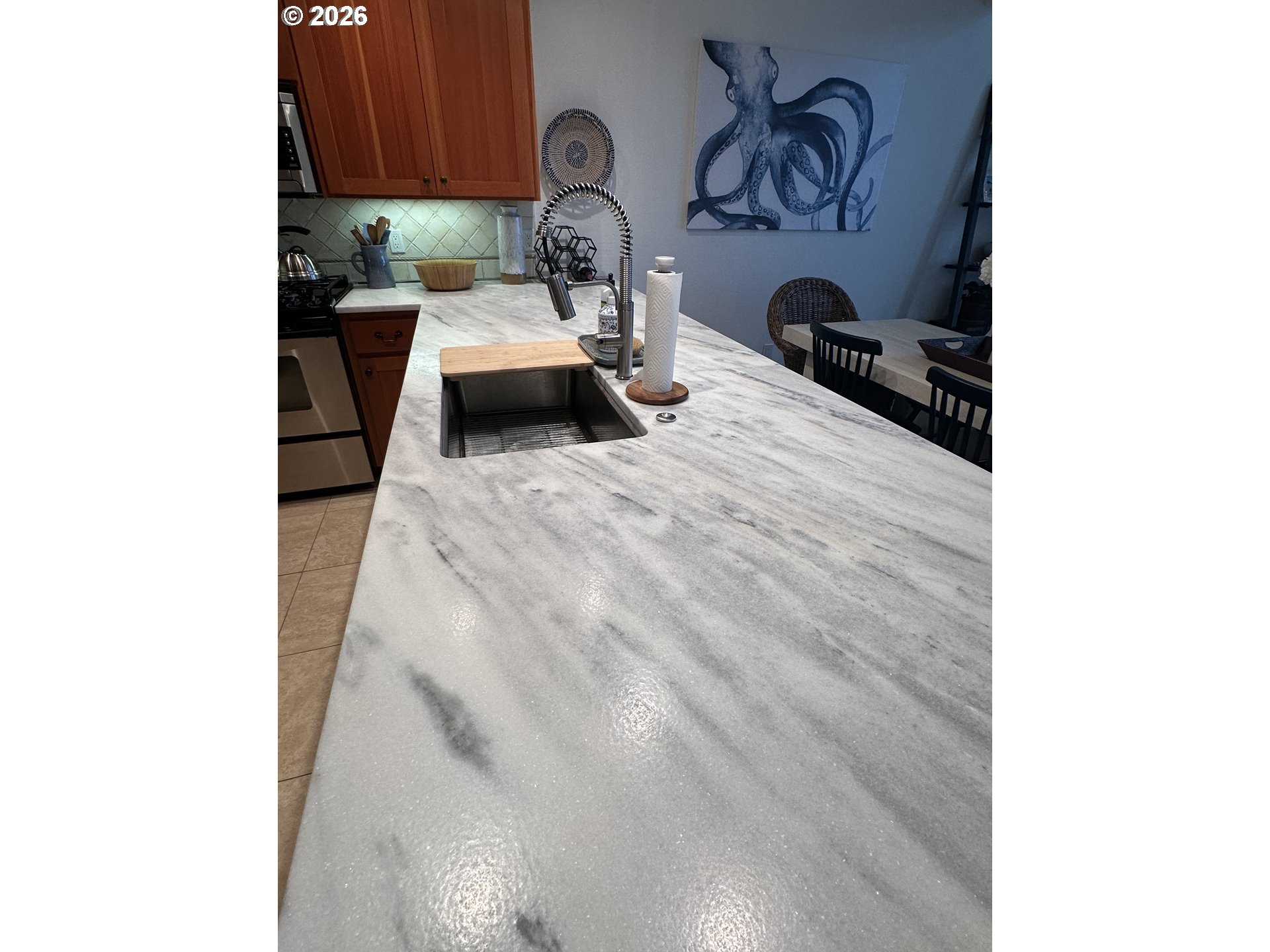 3912 Sunset Boulevard, Unit A202 Seaside, OR 97138 - Photo 12 of 32 a kitchen with a sink and cabinets