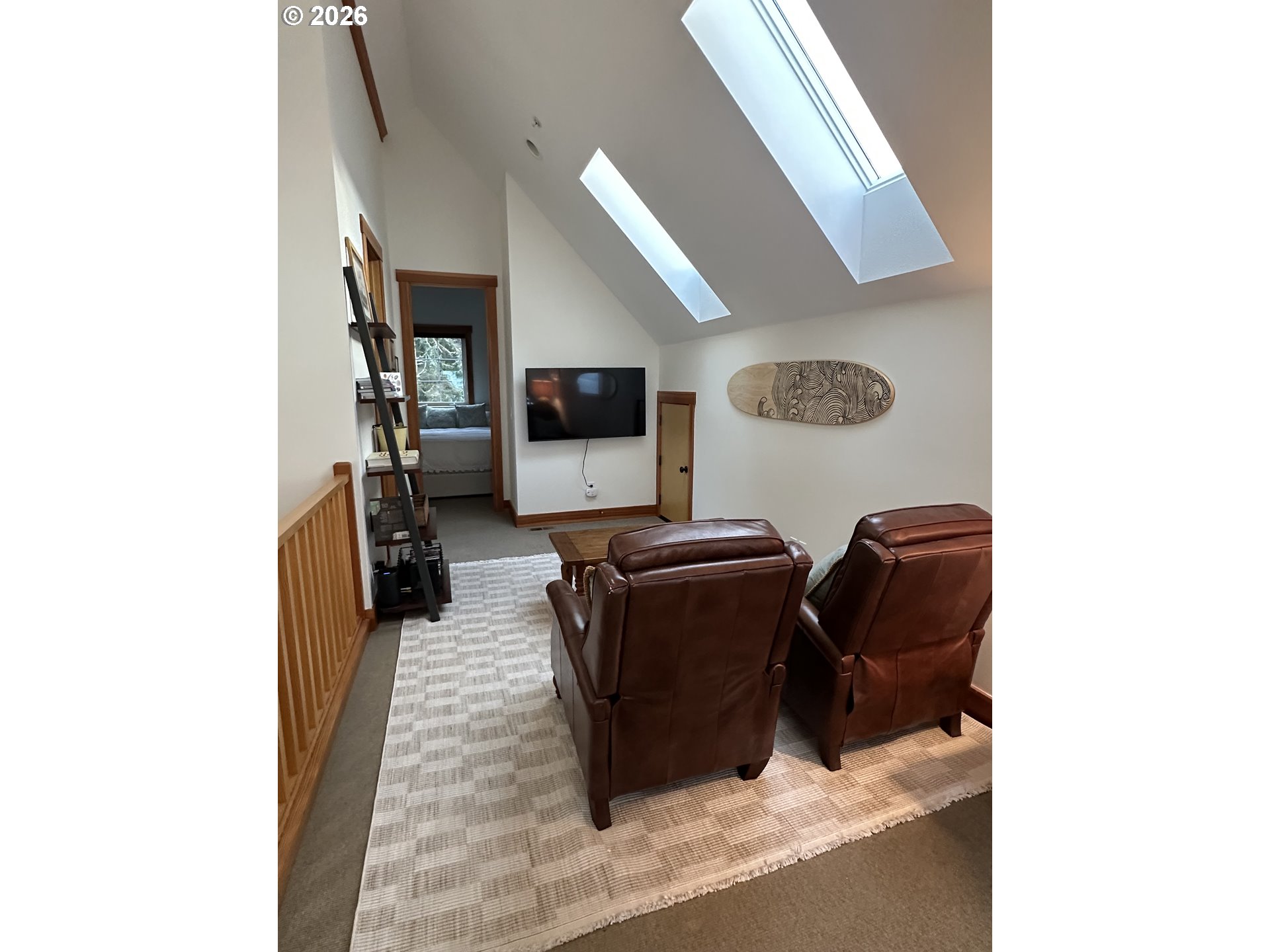 3912 Sunset Boulevard, Unit A202 Seaside, OR 97138 - Photo 23 of 32 a living room with furniture and a flat screen tv