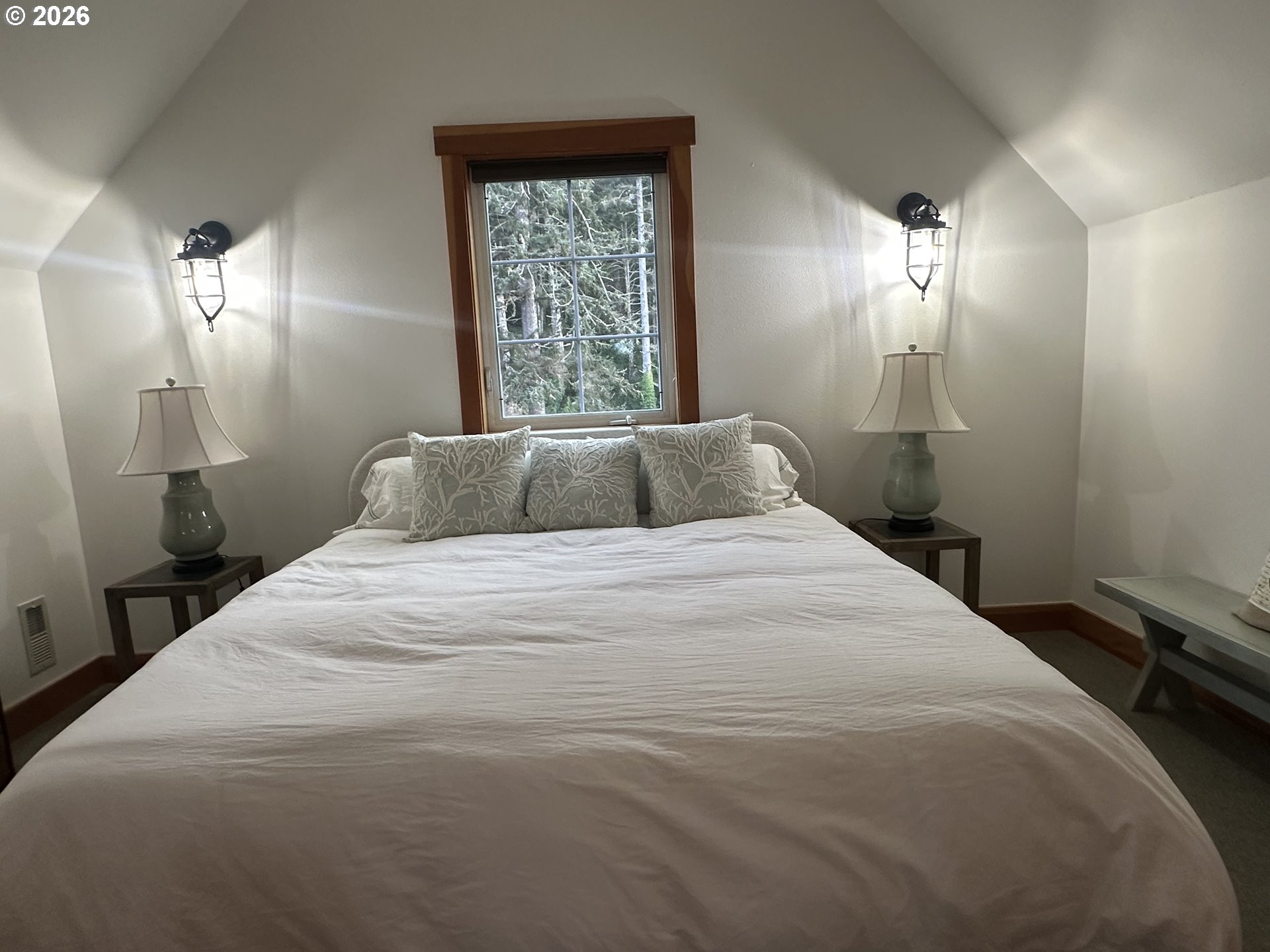 3912 Sunset Boulevard, Unit A202 Seaside, OR 97138 - Photo 26 of 32 a bedroom with a bed and a window