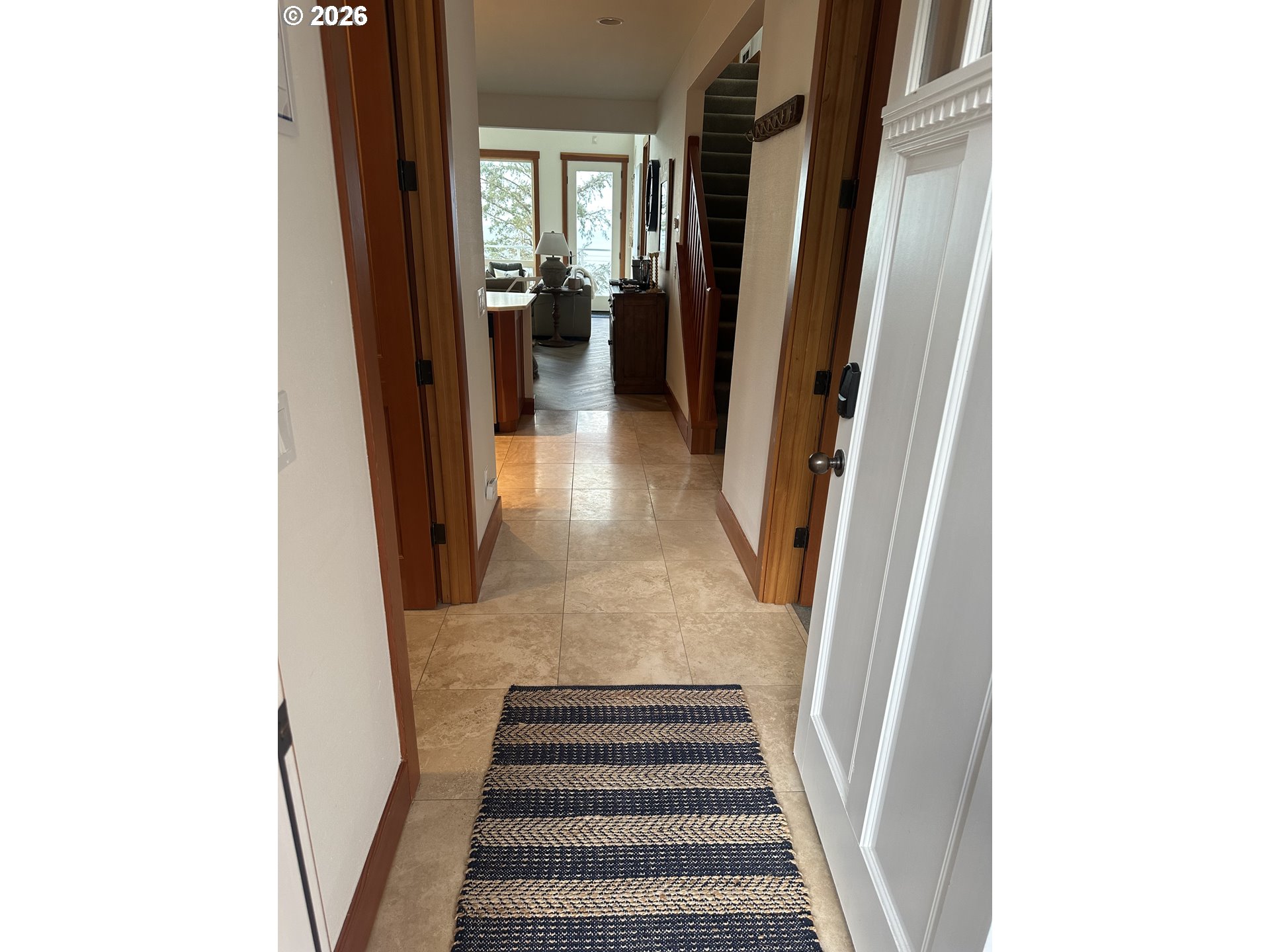 3912 Sunset Boulevard, Unit A202 Seaside, OR 97138 - Photo 5 of 32 a view of a hallway with wooden floor and stairs