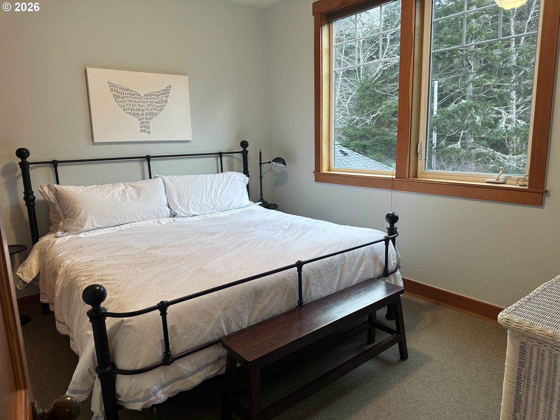 3912 Sunset Boulevard, Unit A202 Seaside, OR 97138 - Photo 6 of 32 a bed sitting in a bedroom next to a window