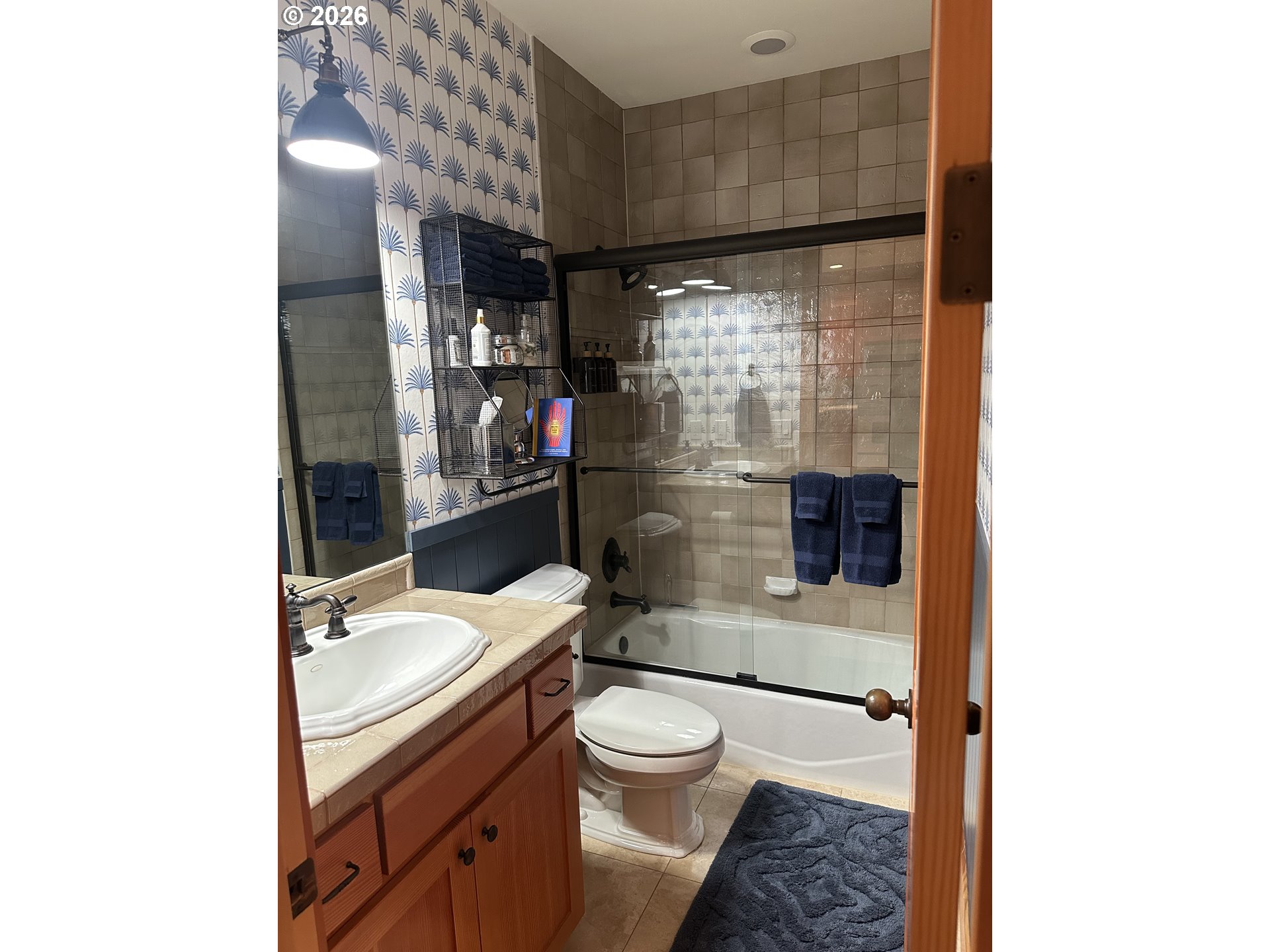 3912 Sunset Boulevard, Unit A202 Seaside, OR 97138 - Photo 8 of 32 a bathroom with a granite countertop toilet sink and shower