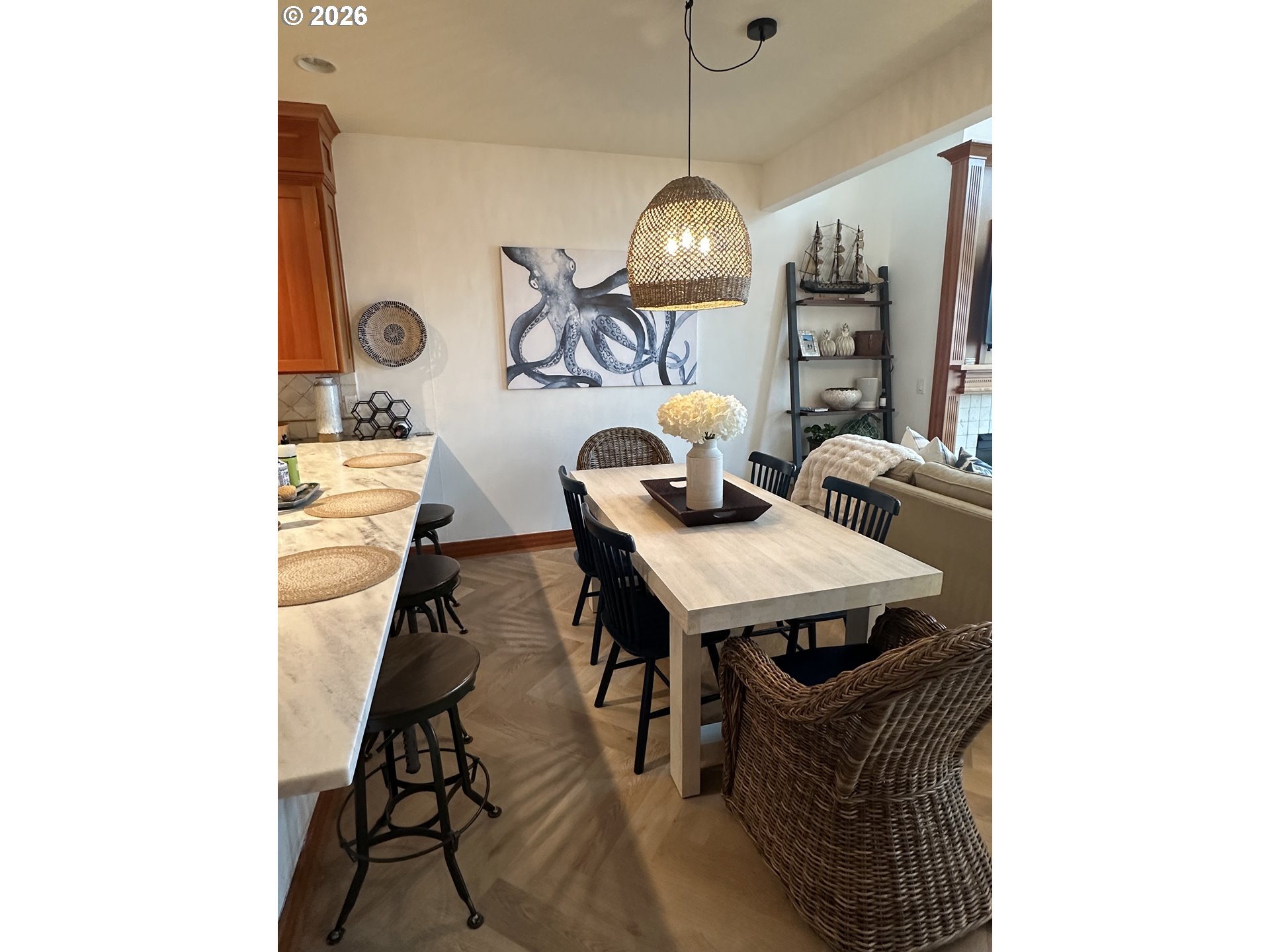 3912 Sunset Boulevard, Unit A202 Seaside, OR 97138 - Photo 10 of 32 a view of a dining room with furniture wooden floor and chandelier