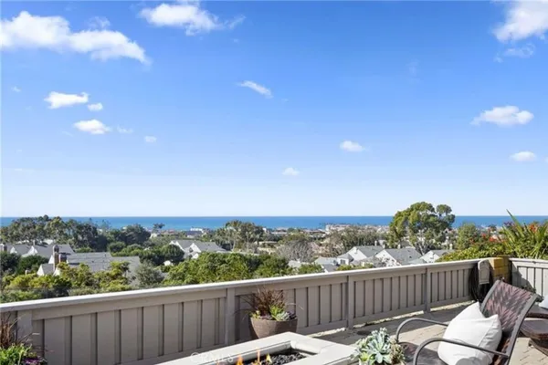 a view of a balcony with wooden fence and floor