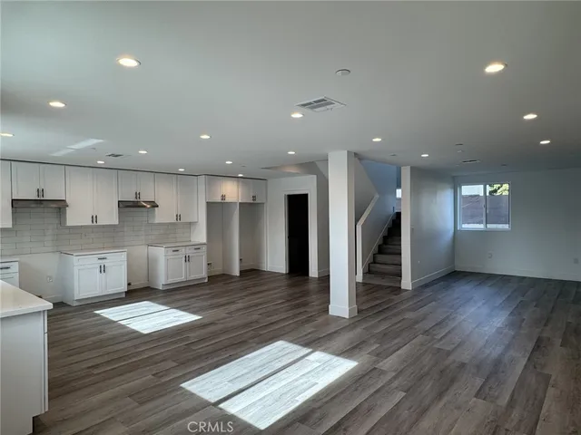 a view of kitchen with cabinets and wooden floor