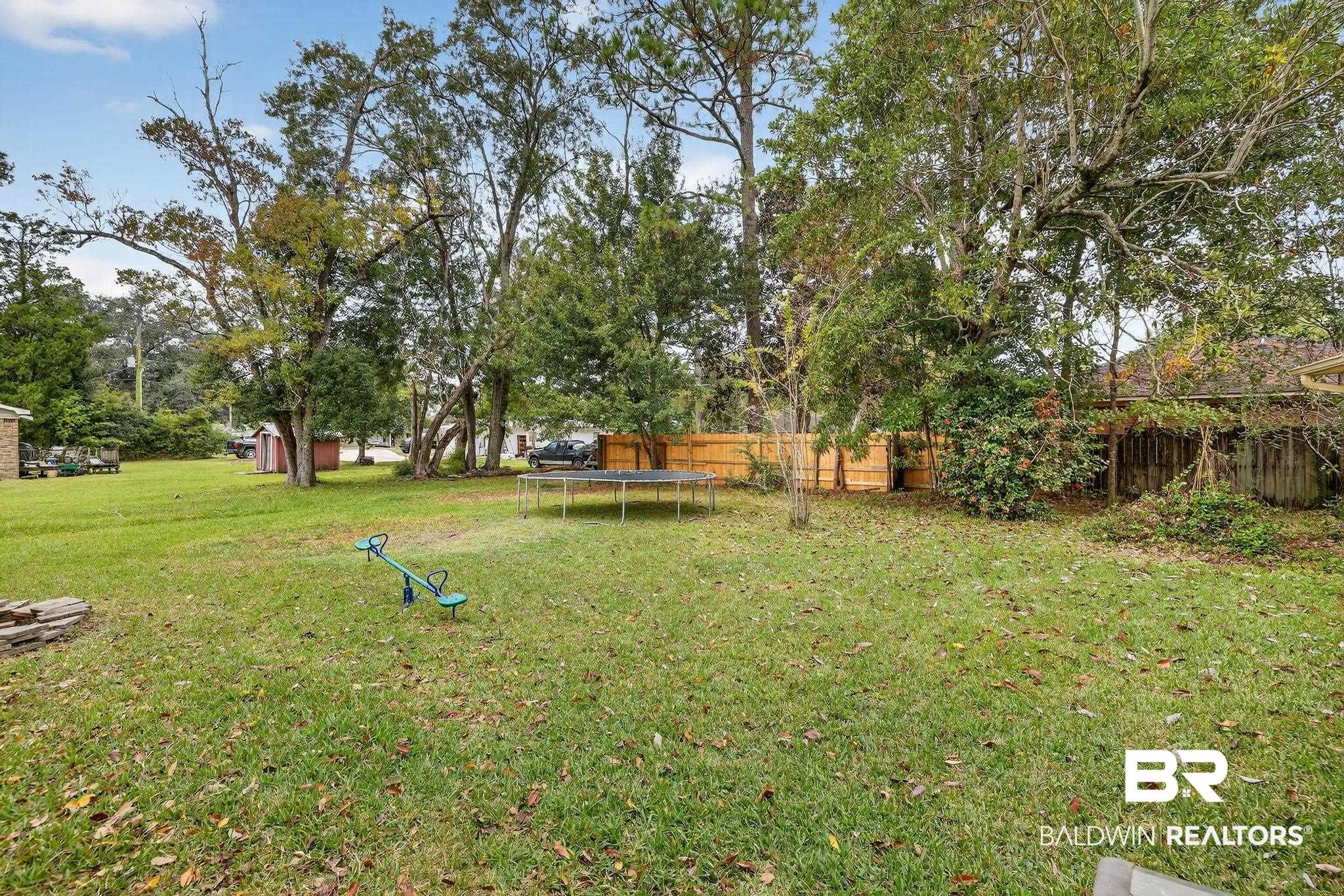 21895 2nd Street Silverhill, AL 36576 - Photo 8 of 43 Partial fenced backyard and view of wooded area